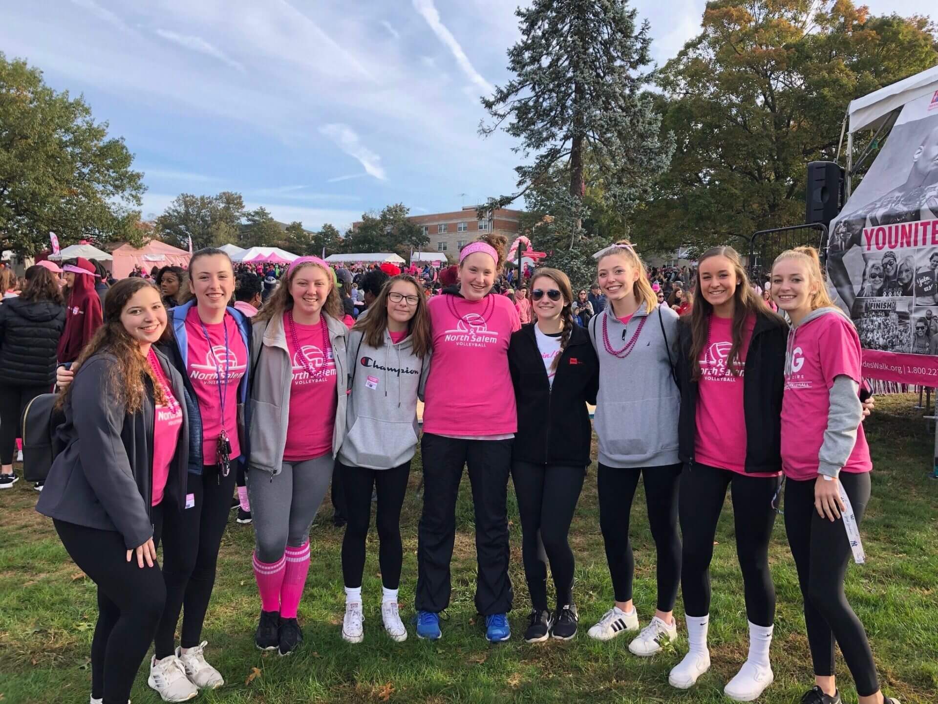 The team poses for a group photo at their Dig Pink fundraiser event